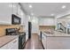 Well-appointed kitchen featuring stainless steel appliances, white cabinets, and ample counter space at 911 Sonoma Dr, Lawrenceville, GA 30045