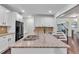 Spacious kitchen featuring granite countertops, white cabinets, stainless appliances, and large center island at 911 Sonoma Dr, Lawrenceville, GA 30045
