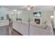 Open-concept living room with fireplace, large couch, hardwood floors, and bright windows at 911 Sonoma Dr, Lawrenceville, GA 30045