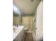 The bathroom has a shower with a curtain, a white sink, and a toilet at 3484 Lynley Mill Ln, Dacula, GA 30019
