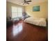 Well-lit bedroom featuring hardwood floors, a ceiling fan, and natural light from the window at 3484 Lynley Mill Ln, Dacula, GA 30019