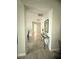 Bright hallway featuring neutral tile flooring and a decorative console table and mirror at 3484 Lynley Mill Ln, Dacula, GA 30019