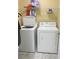 Functional laundry room with a washer, dryer, and shelving for convenient storage at 3484 Lynley Mill Ln, Dacula, GA 30019