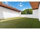 View of serene backyard with a manicured lawn and white walls, offering a tranquil outdoor escape at 367 Parkway Ne Dr # 3, Atlanta, GA 30312