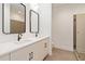 Bright bathroom with double sink vanity, large mirrors, white countertops, and tiled walk-in shower at 367 Parkway Ne Dr # 3, Atlanta, GA 30312