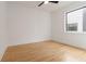 Bedroom featuring a ceiling fan, hardwood floors, white walls, and a modern window overlooking the exterior at 367 Parkway Ne Dr # 3, Atlanta, GA 30312