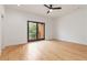 Spacious bedroom with a ceiling fan, sliding glass doors that lead to a balcony, and beautiful hardwood floors at 367 Parkway Ne Dr # 3, Atlanta, GA 30312