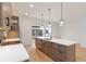 The updated kitchen features wood grain cabinets, stainless appliances, a quartz countertop, and modern pendant lighting at 367 Parkway Ne Dr # 3, Atlanta, GA 30312
