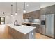 Modern kitchen shows a large island with sink, light wood cabinets, and stainless steel appliances at 367 Parkway Ne Dr # 3, Atlanta, GA 30312