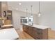 Modern kitchen showcases a large island with sink, light wood cabinets and drawer pulls, and hardwood floors at 367 Parkway Ne Dr # 3, Atlanta, GA 30312