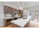Modern kitchen boasts a large island, stainless appliances, custom backsplash, and pendant lighting at 367 Parkway Ne Dr # 3, Atlanta, GA 30312