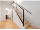 Modern staircase with wood treads, metal railings, and an open view to a bathroom at the landing at 367 Parkway Ne Dr # 3, Atlanta, GA 30312
