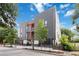 A low-angle view of a modern gray home with wood accents, a black fence, and nearby trees at 367 Parkway Ne Dr # 6, Atlanta, GA 30312