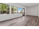 Bright living room featuring luxury vinyl floors, large windows, and a glass door to the exterior at 367 Parkway Ne Dr # 6, Atlanta, GA 30312