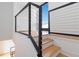 Modern staircase with wood treads, white risers, and a black metal railing, leading to the upper level at 367 Parkway Ne Dr # 6, Atlanta, GA 30312