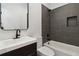 Modern bathroom features a sleek vanity with a black faucet and a shower with gray tiled walls and a niche at 367 Parkway Ne Dr # 9, Atlanta, GA 30312