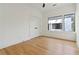 Light-filled bedroom with wood floors, a modern ceiling fan, and a large window at 367 Parkway Ne Dr # 9, Atlanta, GA 30312