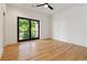Bright bedroom with hardwood floors, a ceiling fan, and sliding glass doors leading to a balcony with a view at 367 Parkway Ne Dr # 9, Atlanta, GA 30312