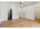Spacious bedroom featuring hardwood floors, white walls, and multiple doorways, including one to the bathroom at 367 Parkway Ne Dr # 9, Atlanta, GA 30312