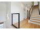Hallway with a staircase, wood floors, metal railings, and minimalist design at 367 Parkway Ne Dr # 9, Atlanta, GA 30312