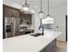 Bright kitchen featuring stainless steel appliances, a large island with sink, and unique pendant lights at 367 Parkway Ne Dr # 9, Atlanta, GA 30312