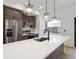 Modern kitchen features stainless steel appliances, custom cabinets, quartz countertops and pendant lighting at 367 Parkway Ne Dr # 9, Atlanta, GA 30312