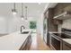 Contemporary open concept kitchen with large island, stainless steel appliances and hardwood flooring at 367 Parkway Ne Dr # 9, Atlanta, GA 30312