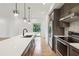 Open kitchen featuring a quartz countertop island, stainless steel appliances, and minimalist pendant lights at 367 Parkway Ne Dr # 9, Atlanta, GA 30312