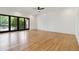 Spacious living room featuring hardwood floors, white walls, a ceiling fan and sliding glass doors at 367 Parkway Ne Dr # 9, Atlanta, GA 30312