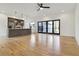 Living room with hardwood floors leading into kitchen with center island, stainless steel appliances, and sliding doors at 367 Parkway Ne Dr # 9, Atlanta, GA 30312