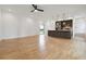 Living room with hardwood floors leading into kitchen with center island, stainless steel appliances and modern lighting at 367 Parkway Ne Dr # 9, Atlanta, GA 30312