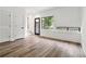 Living room with hardwood floors, large window, white walls, and two closets near the front door at 367 Parkway Ne Dr # 9, Atlanta, GA 30312