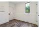Neutral-toned room featuring wood-look floors, a window, and white walls at 367 Parkway Ne Dr # 9, Atlanta, GA 30312