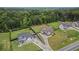 A high-angle aerial view highlights the property's prime location with lush surroundings and a large backyard at 1660 Chandler Rd, Lawrenceville, GA 30045