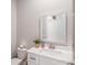 Bathroom with white cabinets, sink, tile flooring, and a decorative framed mirror at 1660 Chandler Rd, Lawrenceville, GA 30045