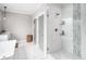 Luxurious bathroom featuring a glass-enclosed shower with tile surround, plus a soaking tub at 1660 Chandler Rd, Lawrenceville, GA 30045