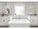 Bright bathroom features a freestanding soaking tub and double sink vanities with modern lighting at 1660 Chandler Rd, Lawrenceville, GA 30045