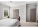 Relaxing bedroom with neutral walls, carpet, and doors to closet and bathroom at 1660 Chandler Rd, Lawrenceville, GA 30045
