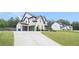 Charming two-story home with a white brick exterior, manicured lawn, and attached two-car garage at 1660 Chandler Rd, Lawrenceville, GA 30045