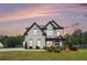 Beautiful two-story home with a manicured lawn, elegant landscaping, and a welcoming front porch at 1660 Chandler Rd, Lawrenceville, GA 30045