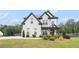 Stunning two-story home with a manicured lawn, professional landscaping, and a paved drive way at 1660 Chandler Rd, Lawrenceville, GA 30045
