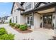 Charming covered front porch with brick columns, double front doors with wreaths, and rocking chairs at 1660 Chandler Rd, Lawrenceville, GA 30045