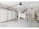 Spacious garage with epoxy floors, garage door opener, built-in storage, and access to the main house at 1660 Chandler Rd, Lawrenceville, GA 30045
