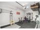 Garage gym includes weightlifting equipment, stationary bicycle, overhead storage, and ample natural light at 1660 Chandler Rd, Lawrenceville, GA 30045