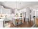 Spacious kitchen featuring a center island with seating, stainless steel appliances, and modern lighting at 1660 Chandler Rd, Lawrenceville, GA 30045