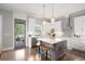 Bright kitchen with a center island, pendant lighting, stainless steel appliances, and access to a screened porch at 1660 Chandler Rd, Lawrenceville, GA 30045