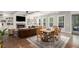 Spacious living room and dining area with fireplace, coffered ceiling, hardwood floors and natural lighting at 1660 Chandler Rd, Lawrenceville, GA 30045