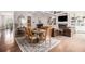 Spacious open floorplan living room and dining area with fireplace, coffered ceiling, and hardwood floors at 1660 Chandler Rd, Lawrenceville, GA 30045
