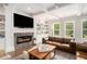 Spacious living room features a fireplace, hardwood floors, built in shelving, and natural lighting at 1660 Chandler Rd, Lawrenceville, GA 30045