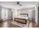 Main bedroom features hardwood floors, two windows for natural light, and a ceiling fan at 1660 Chandler Rd, Lawrenceville, GA 30045